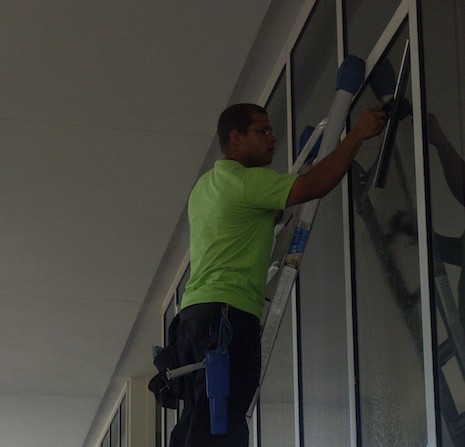 Andy cleaning windows on a ladder, 2012